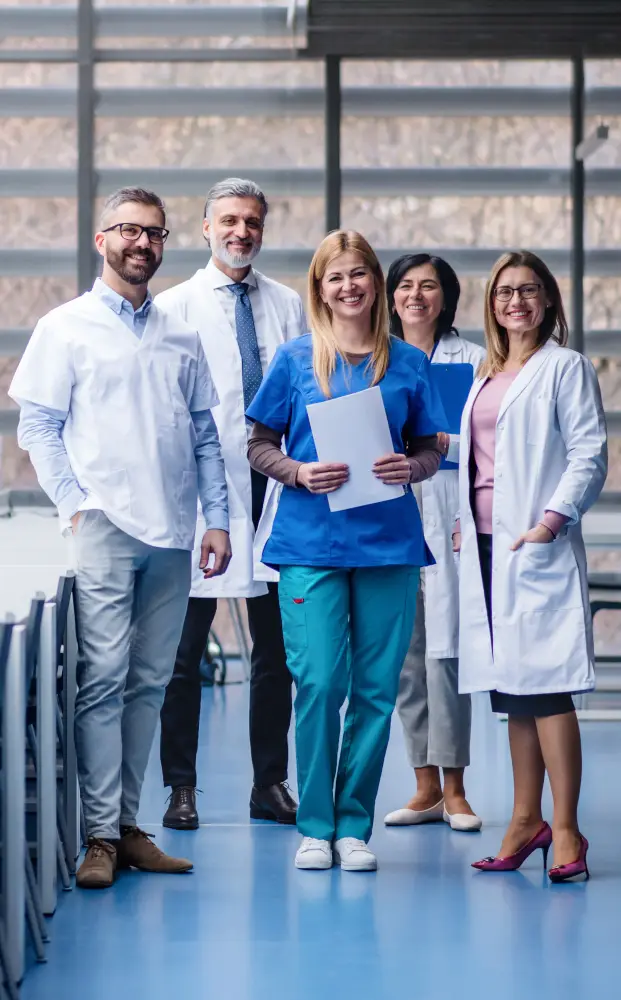 Group of doctors standing in corridor on medical conference.